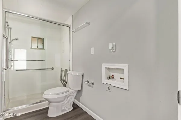 a bathroom with a toilet sink and shower