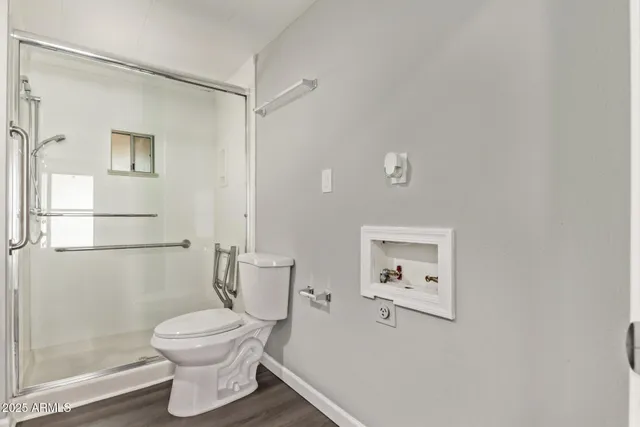 a bathroom with a toilet sink and shower