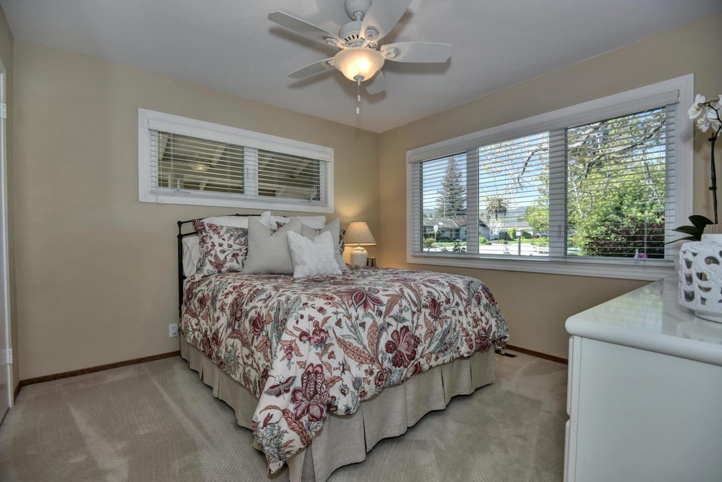 12338 Brookglen Drive Saratoga, CA 95070 - Photo 11 of 18 a bedroom with a bed and a chandelier