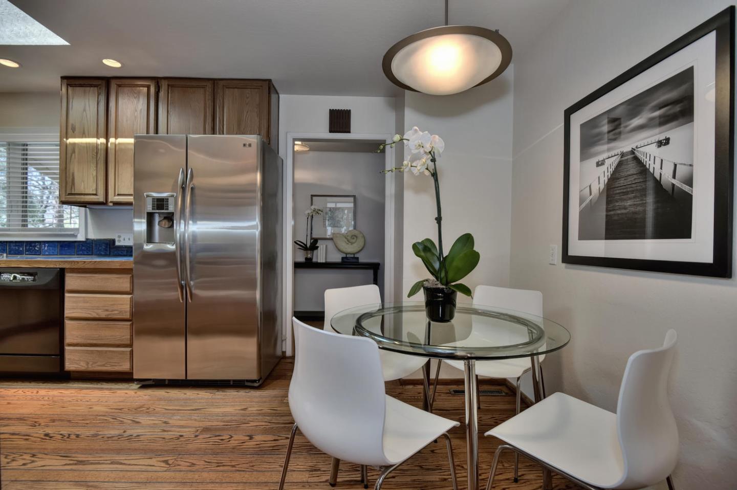 12338 Brookglen Drive Saratoga, CA 95070 - Photo 4 of 18 a dining room with furniture and a chandelier