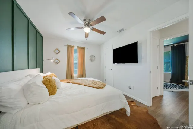 a bedroom with a bed and a flat screen tv