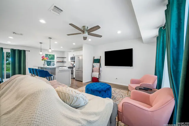 a living room with furniture and a flat screen tv