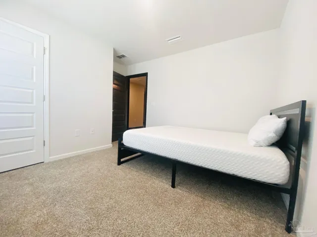 a bedroom with a bed and a cabinets
