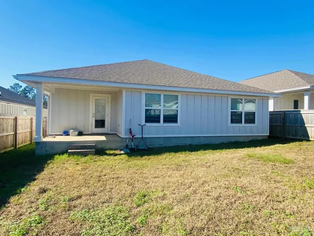 a swimming pool with outdoor seating and yard