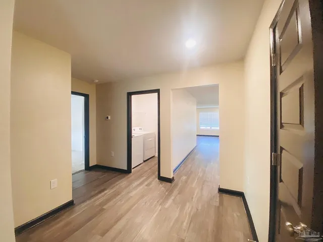 a view of hallway with wooden floor