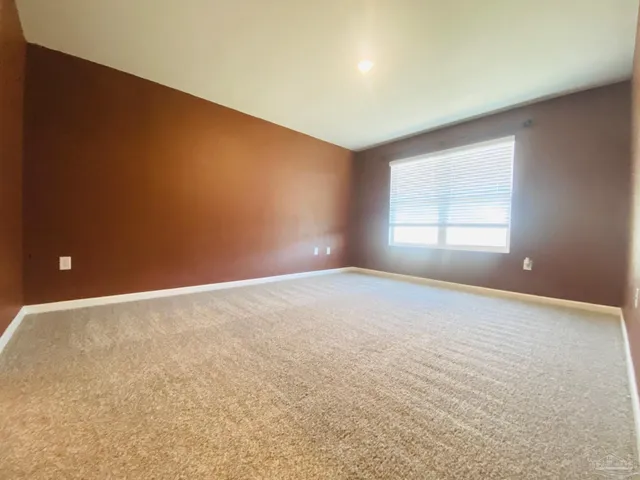 an empty room with windows and closet