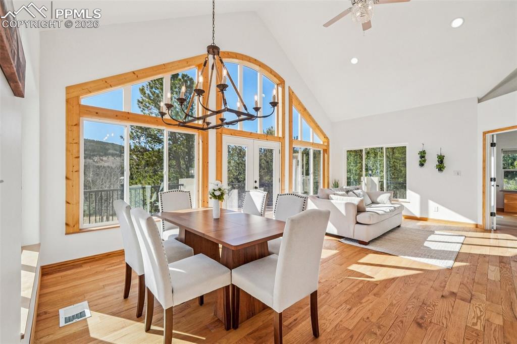507 Yorktown Road Cripple Creek, CO 80813 - Photo 11 of 50 a view of a dining room with furniture wooden floor and a chandelier