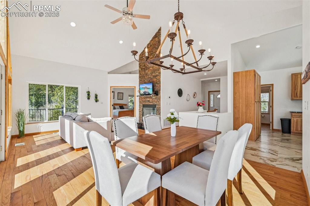 507 Yorktown Road Cripple Creek, CO 80813 - Photo 13 of 50 a view of a dining room with furniture wooden floor and chandelier