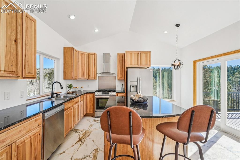 507 Yorktown Road Cripple Creek, CO 80813 - Photo 16 of 50 a kitchen with stainless steel appliances granite countertop a stove a sink a refrigerator cabinets and a chairs