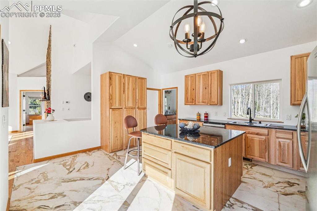 507 Yorktown Road Cripple Creek, CO 80813 - Photo 18 of 50 a kitchen with a sink and a refrigerator
