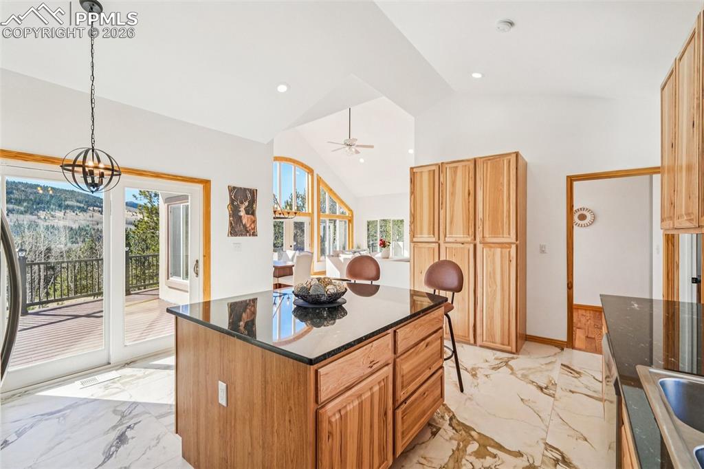 507 Yorktown Road Cripple Creek, CO 80813 - Photo 19 of 50 a kitchen with stainless steel appliances granite countertop a stove a sink and a refrigerator
