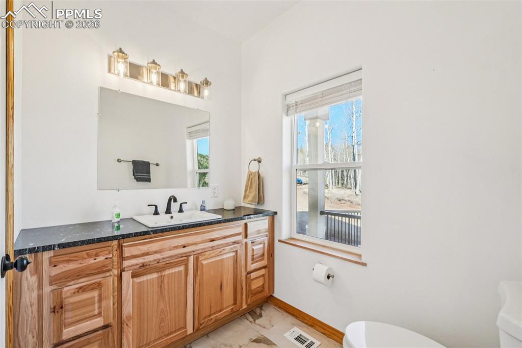 507 Yorktown Road Cripple Creek, CO 80813 - Photo 21 of 50 a bathroom with a sink a toilet and mirror