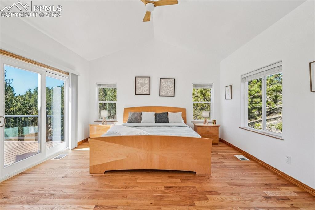 507 Yorktown Road Cripple Creek, CO 80813 - Photo 24 of 50 a spacious bedroom with a bed and large windows
