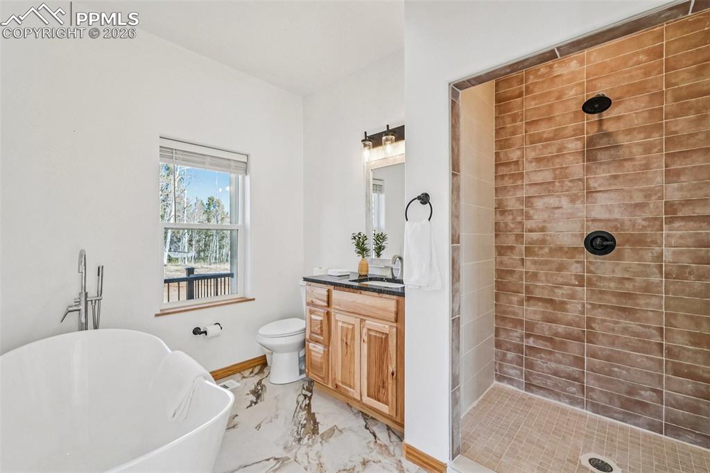 507 Yorktown Road Cripple Creek, CO 80813 - Photo 25 of 50 a white bath tub sitting next to a white sink and a shower
