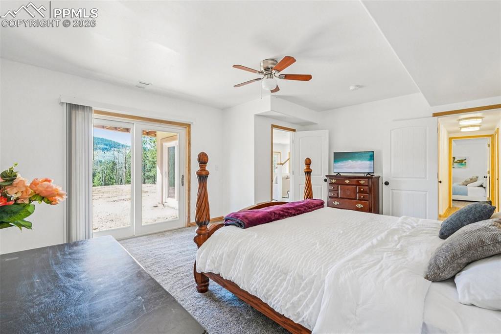 507 Yorktown Road Cripple Creek, CO 80813 - Photo 27 of 50 a bedroom with a large bed and a window