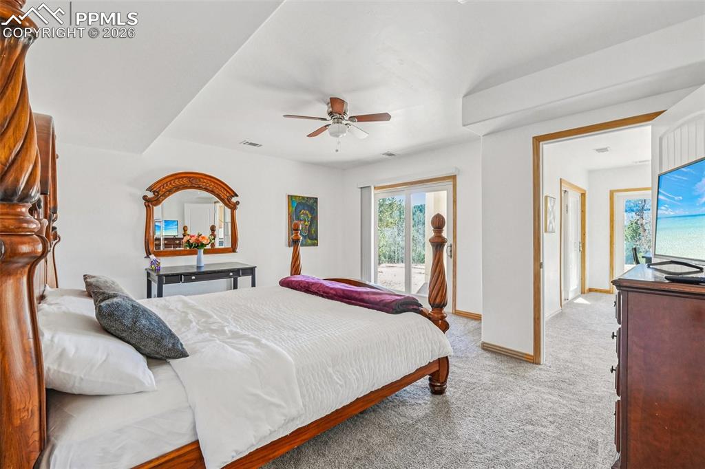 507 Yorktown Road Cripple Creek, CO 80813 - Photo 28 of 50 a bedroom with bed and a chandelier