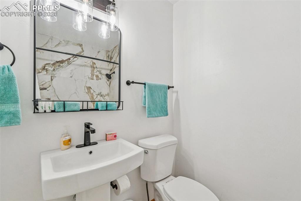 507 Yorktown Road Cripple Creek, CO 80813 - Photo 29 of 50 a bathroom with a sink and mirror with toilet