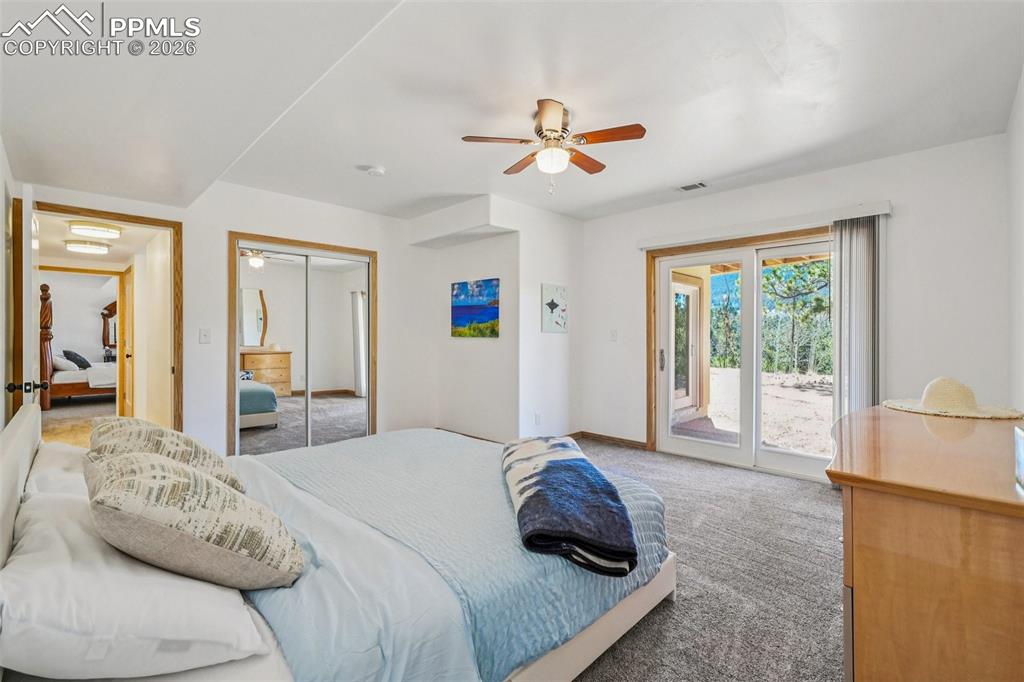 507 Yorktown Road Cripple Creek, CO 80813 - Photo 31 of 50 a bedroom with a large bed and a large window