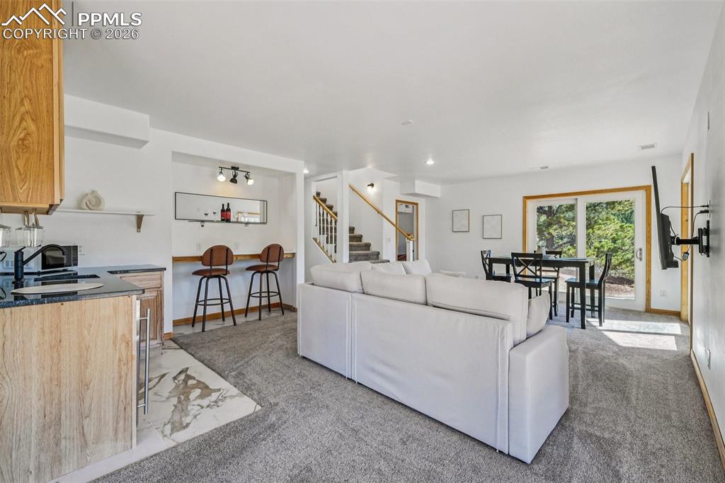 507 Yorktown Road Cripple Creek, CO 80813 - Photo 35 of 50 a living room with furniture and a dining table with kitchen view