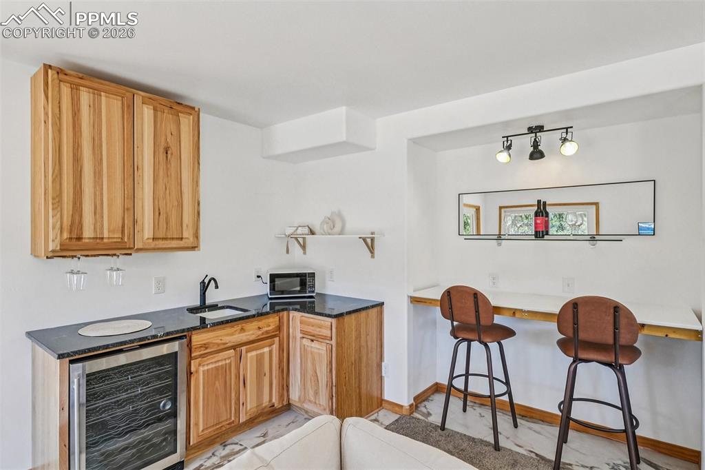 507 Yorktown Road Cripple Creek, CO 80813 - Photo 38 of 50 a kitchen with stainless steel appliances granite countertop a stove a sink and a cabinets