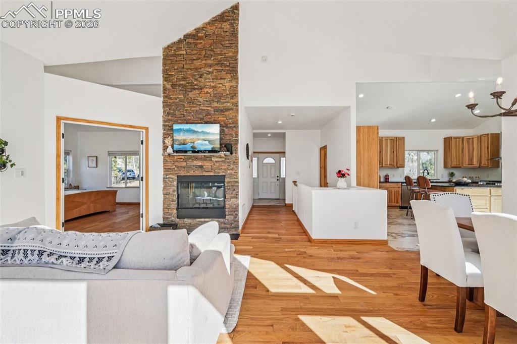 507 Yorktown Road Cripple Creek, CO 80813 - Photo 6 of 50 a living room with furniture a fireplace and kitchen view
