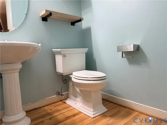 a white toilet sitting next to a bathroom sink