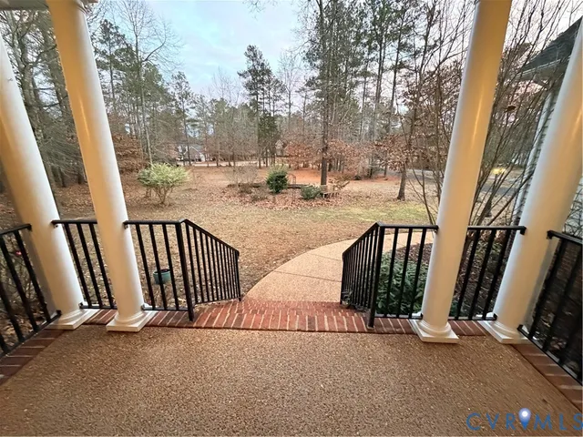 a view of staircase and house with wooden fence and floor