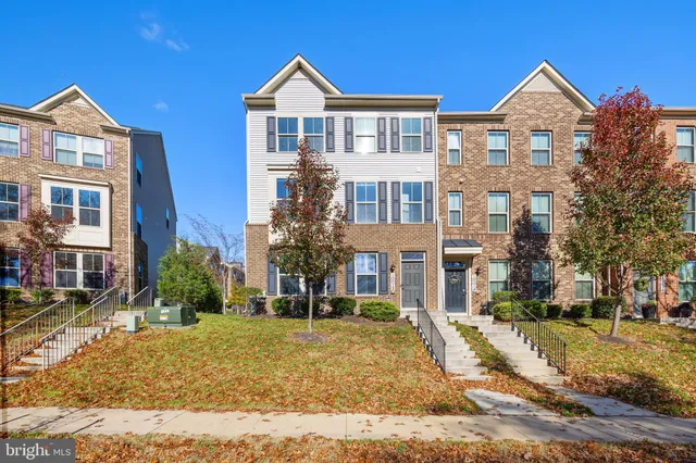 a front view of a residential apartment building with a yard