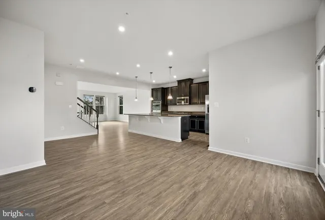 a view of kitchen with microwave and cabinets