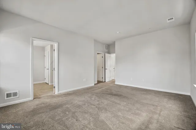 a view of an empty room and closet area