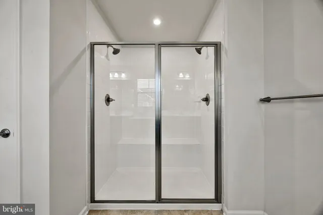 a bathroom with a glass shower door