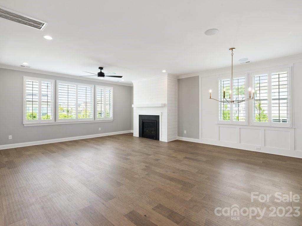 14839 Laura Michelle Road, Unit 66 Huntersville, NC 28078 - Photo 8 of 42 an empty room with wooden floor and windows