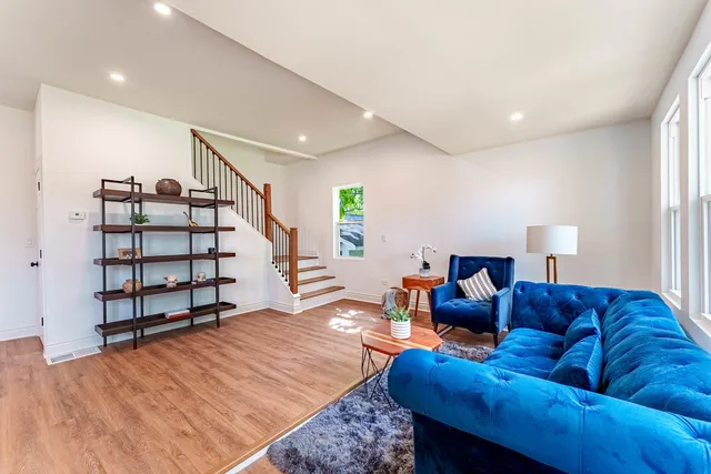 a living room with furniture and wooden floor