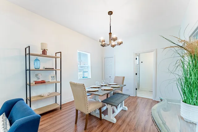 a view of a dining room with furniture wooden floor and chandelier