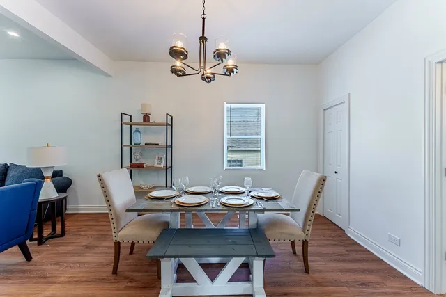 a view of a dining room with furniture wooden floor and chandelier