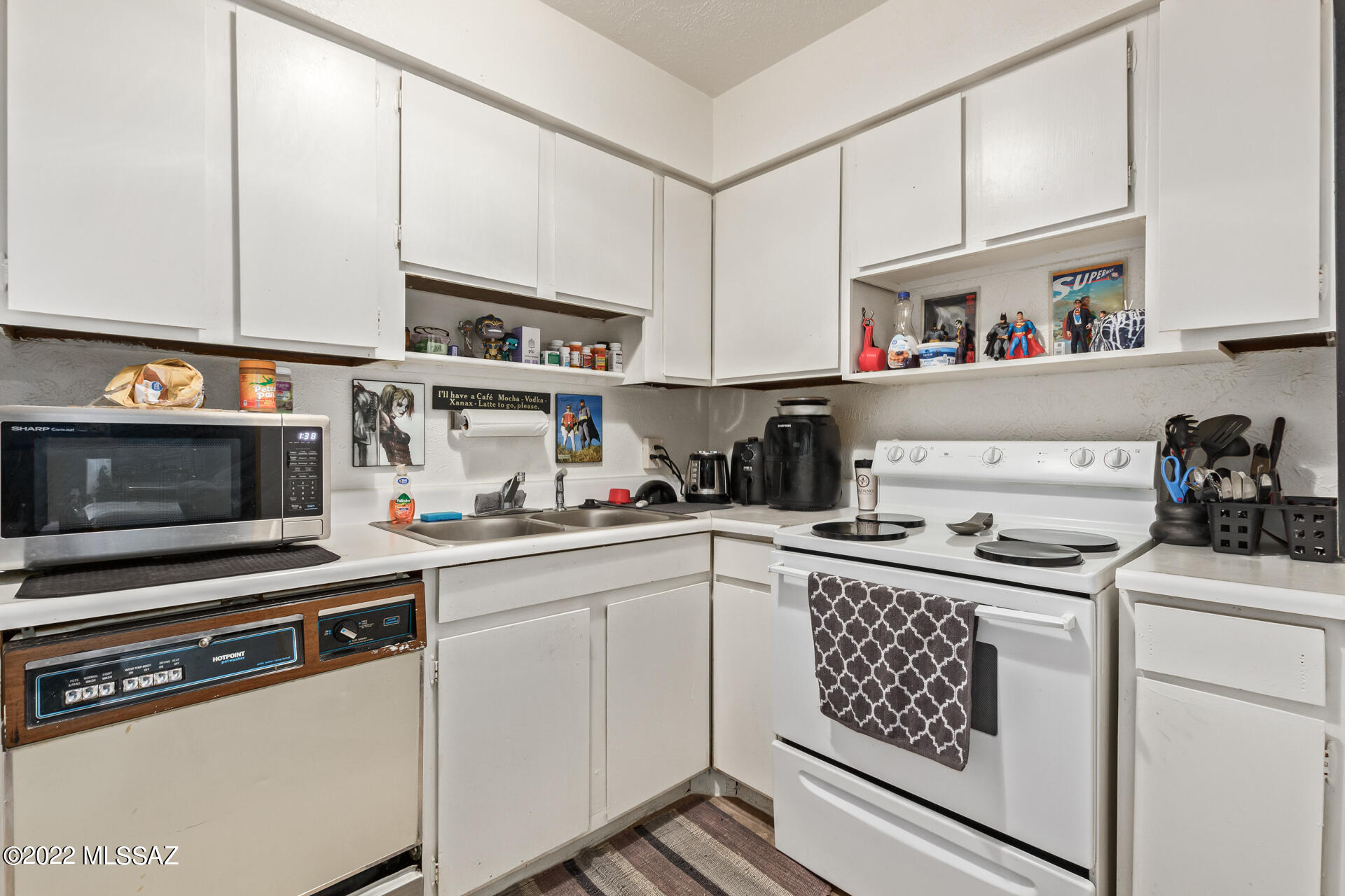 1620 North Wilmot Road, Unit D273 Tucson, AZ 85712 - Photo 9 of 15 a kitchen with stainless steel appliances a sink stove and cabinets