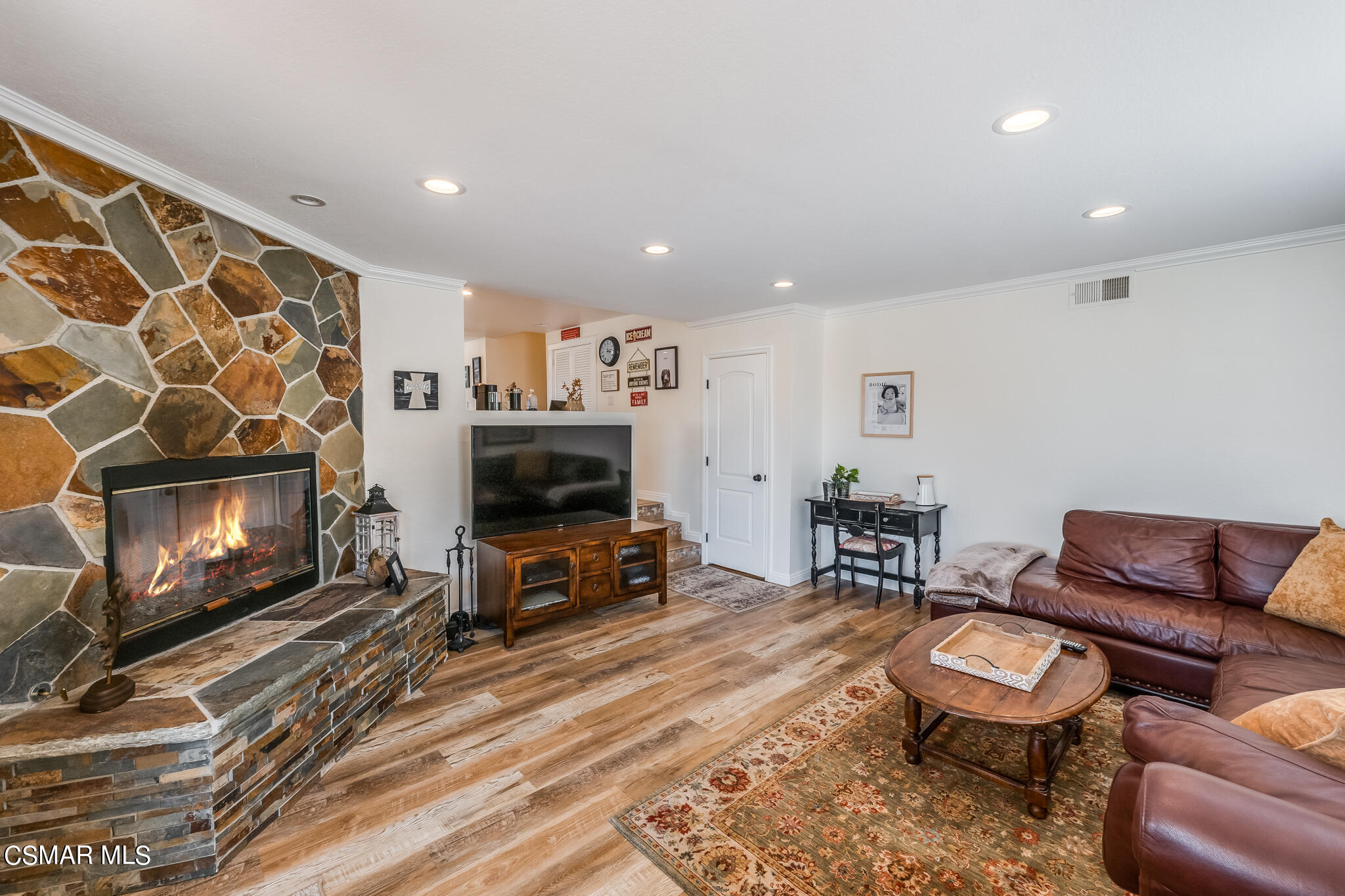 5765 Oak Knolls Road Simi Valley, CA 93063 - Photo 25 of 71 a living room with furniture a flat screen tv and a fireplace