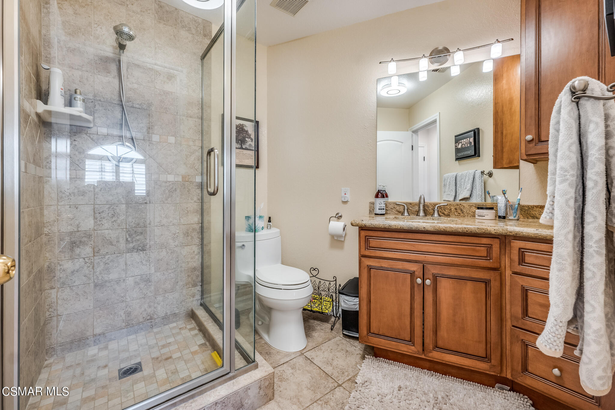 5765 Oak Knolls Road Simi Valley, CA 93063 - Photo 39 of 71 a bathroom with a granite countertop sink toilet and shower