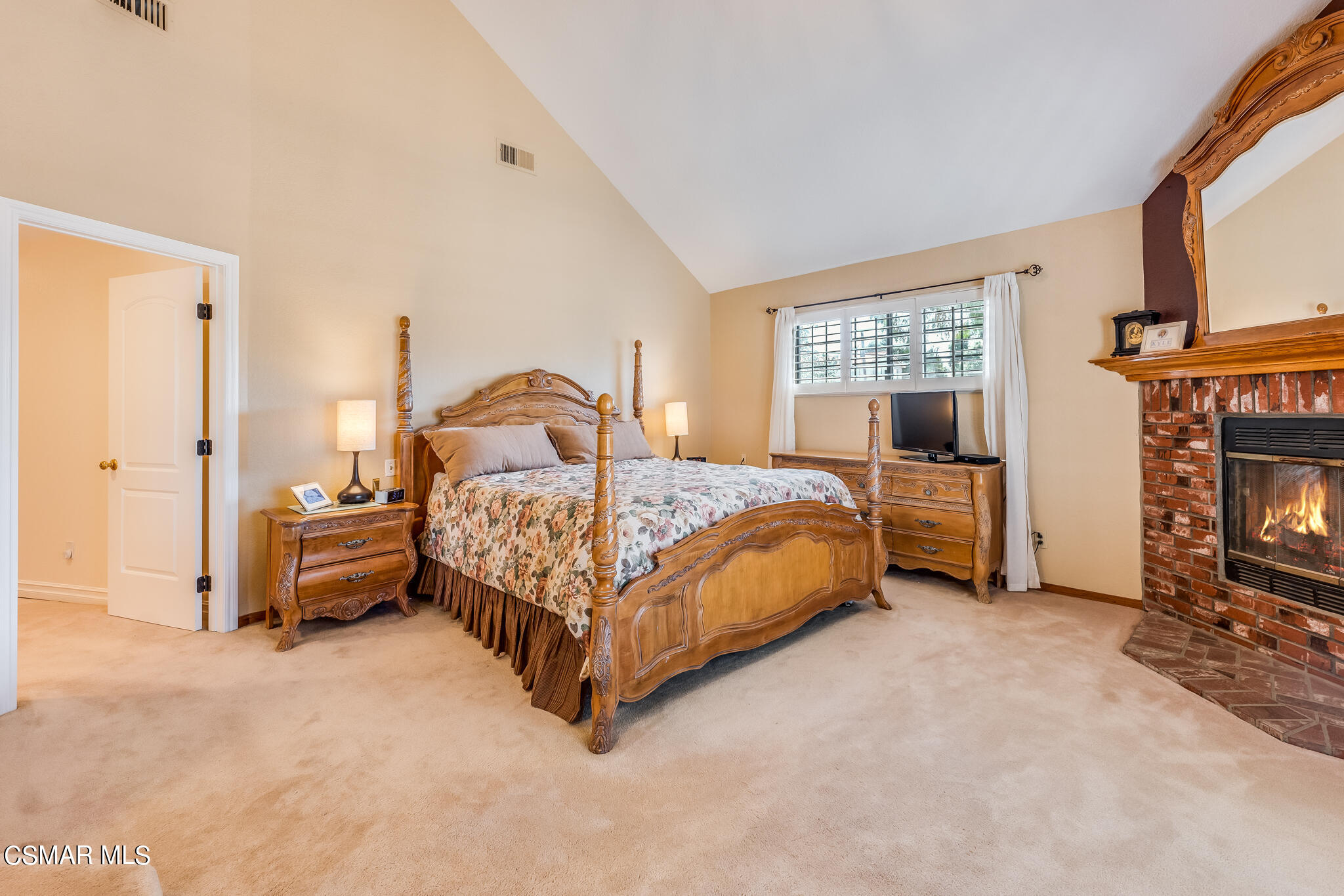 5765 Oak Knolls Road Simi Valley, CA 93063 - Photo 40 of 71 a bedroom with a bed and a fireplace