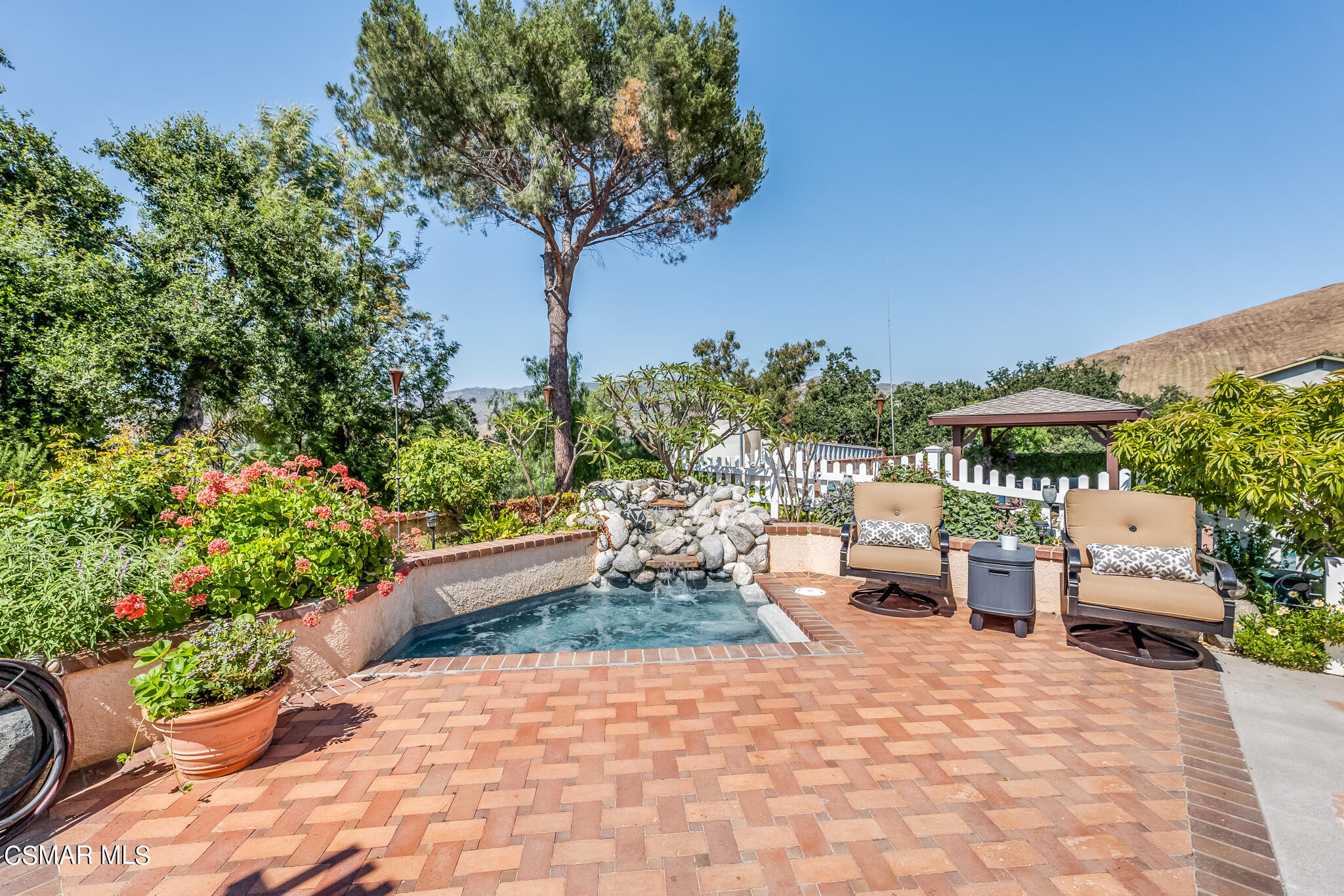 5765 Oak Knolls Road Simi Valley, CA 93063 - Photo 59 of 71 a view of a patio with table and chairs potted plants