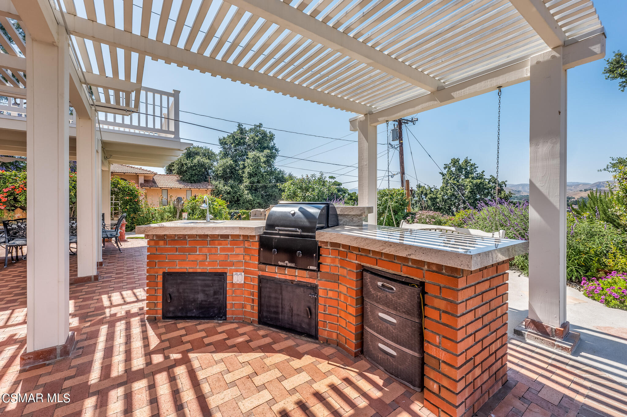 5765 Oak Knolls Road Simi Valley, CA 93063 - Photo 60 of 71 a kitchen with stainless steel appliances granite countertop a stove a sink and a microwave