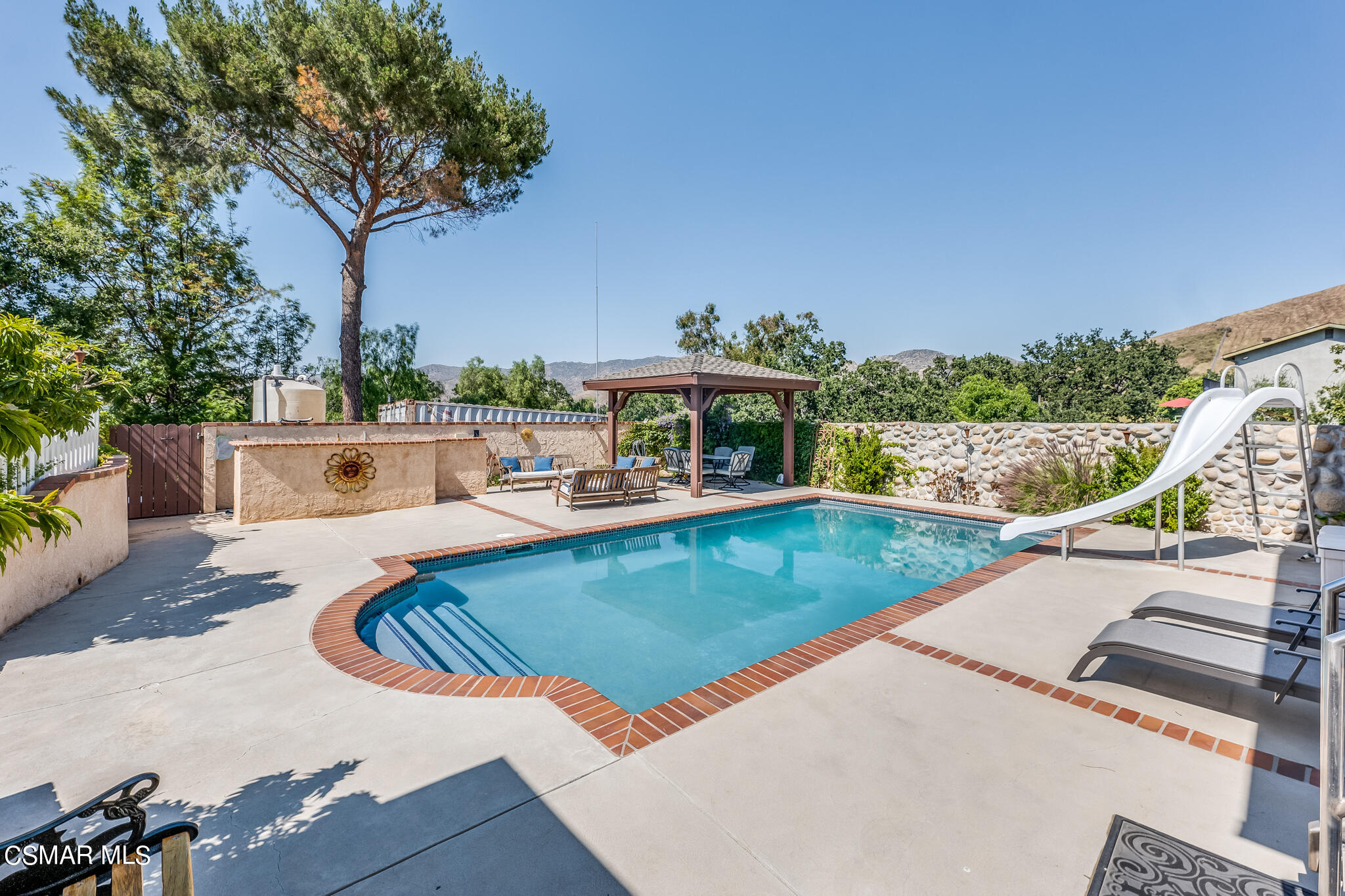 5765 Oak Knolls Road Simi Valley, CA 93063 - Photo 63 of 71 a view of a swimming pool with lounge chair