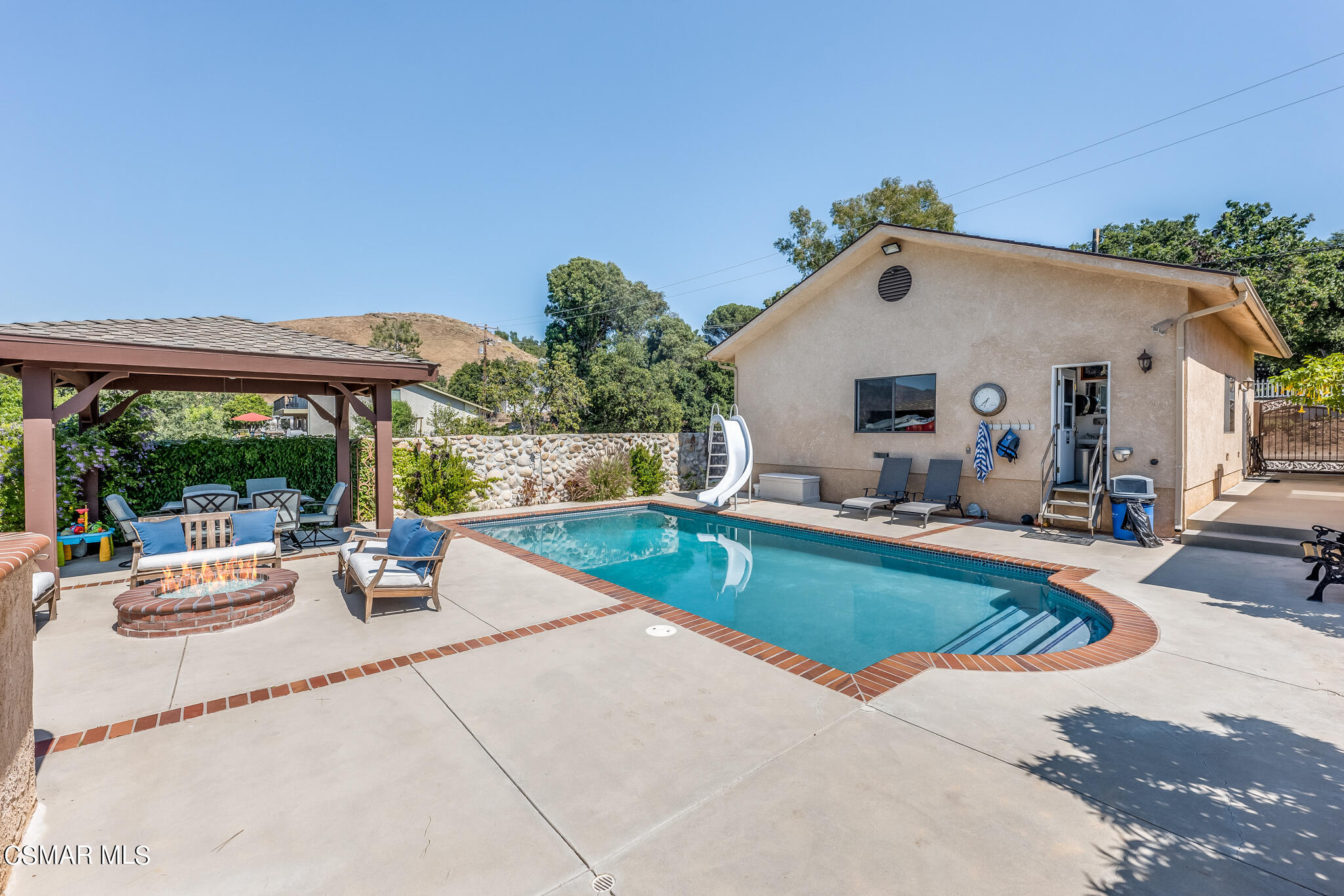 5765 Oak Knolls Road Simi Valley, CA 93063 - Photo 64 of 71 a view of a house with sitting area and swimming pool