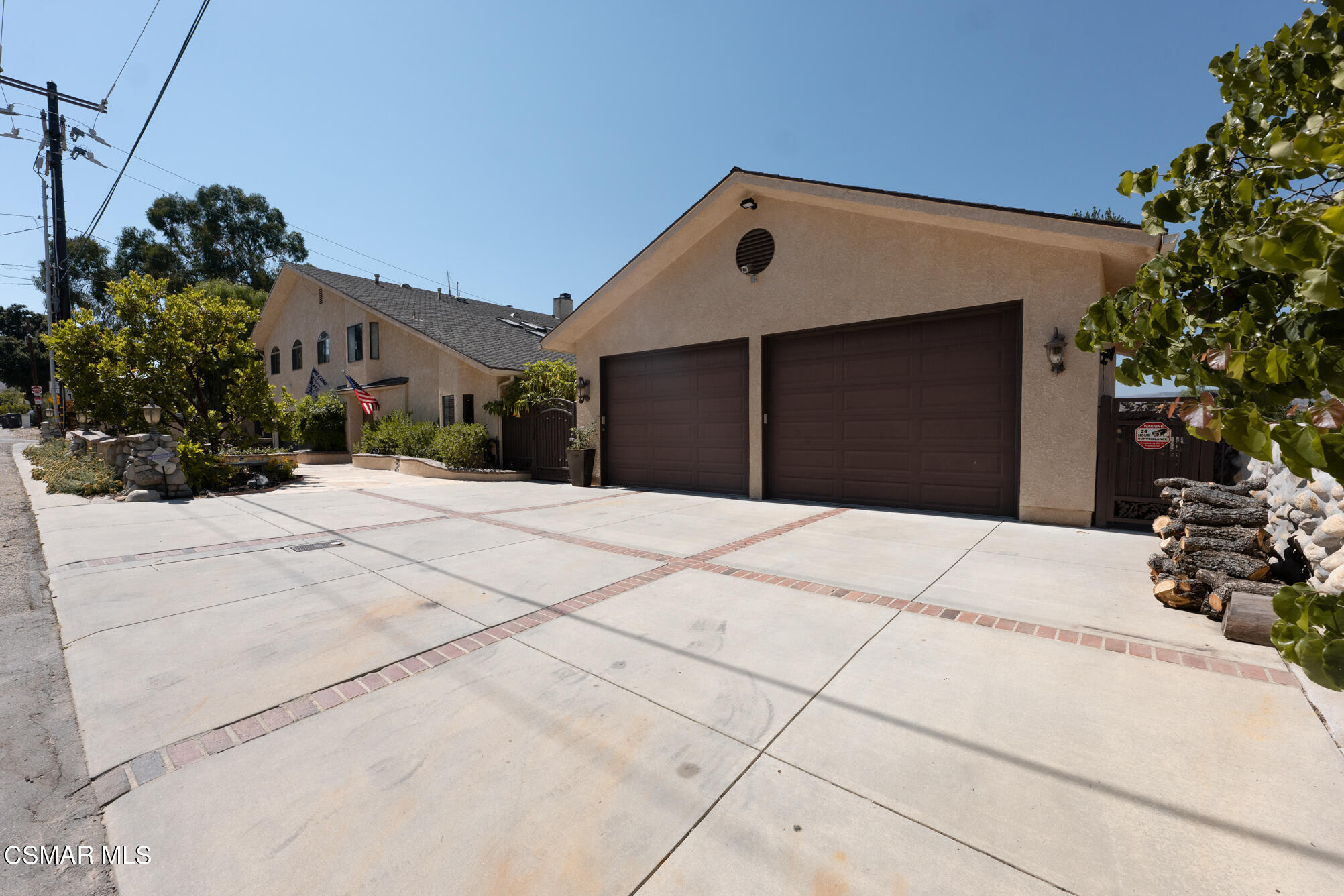 5765 Oak Knolls Road Simi Valley, CA 93063 - Photo 68 of 71 a front view of a house with a yard and garage