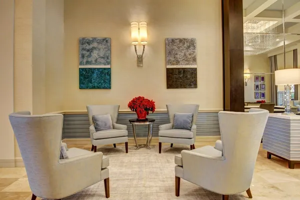 a very nice looking dining room with kitchen island stainless steel appliances a table and chairs