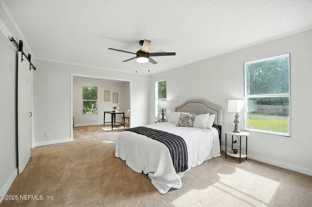 a spacious bedroom with a large bed and a window