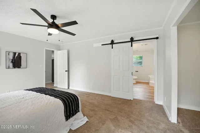 a bedroom with a bed and a ceiling fan