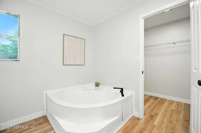 a white bath tub sitting in a bathroom