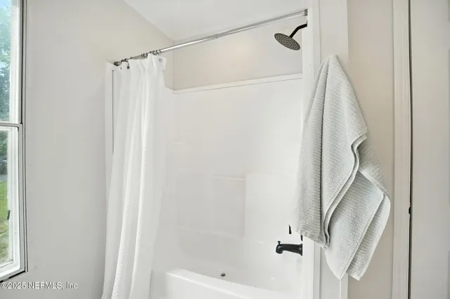 a bathroom with a shower and a tub