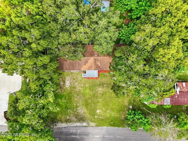 an aerial view of a house with a yard